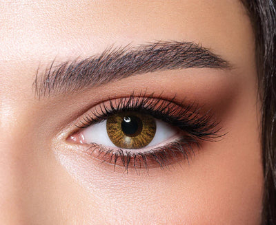 Close-up of an eye with brown eye make-up wearing Bella Natural Cool Hazel colour contact lens