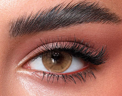Close-up of an eye wearing Bella One Day Hazel Beige colour contact lens with pink makeup